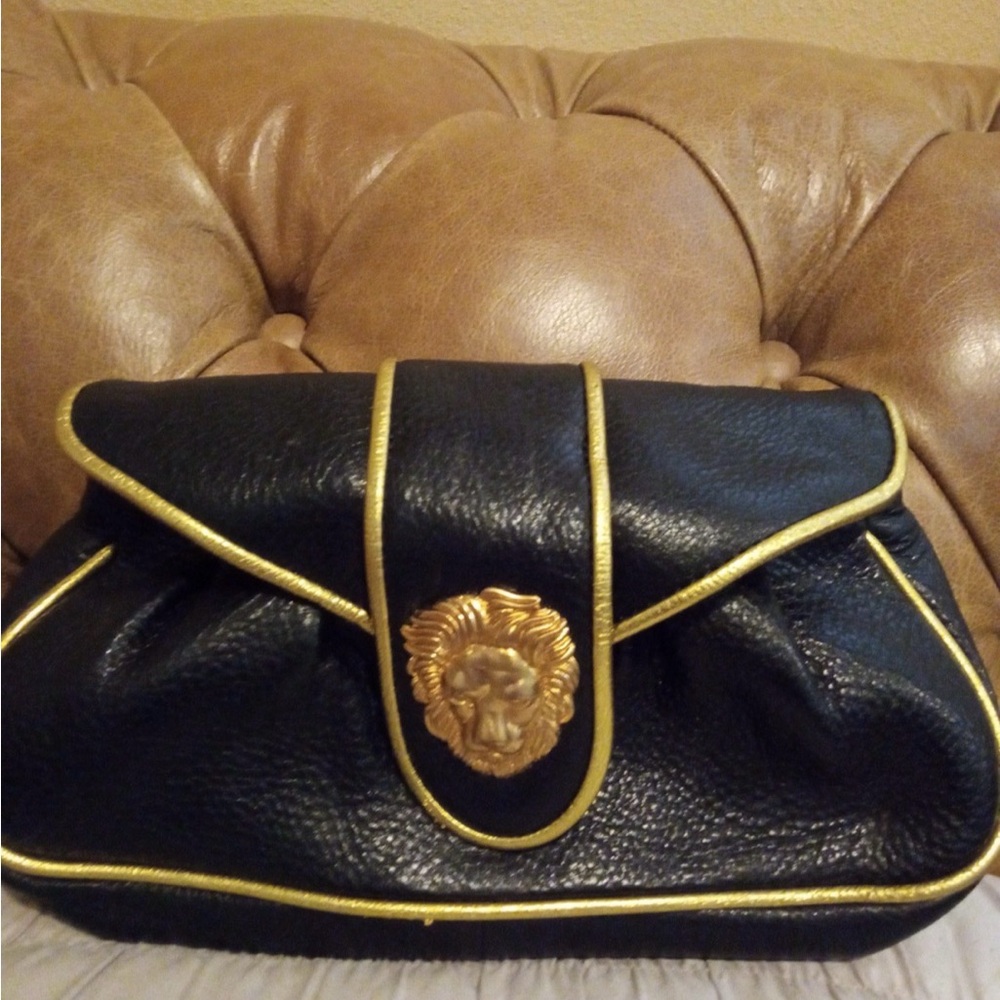 Dooney and Bourke Black and Gold Lion Emblem Clutch